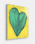 Love Note 2 art print: a tall green-teal heart with thick textured brushstrokes on a bright yellow background, signed in pink, mounted under plexi with a frameless finish