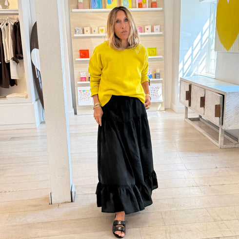 Yellow sweatshirt layered over grey with black maxi skirt, everyday casual style
