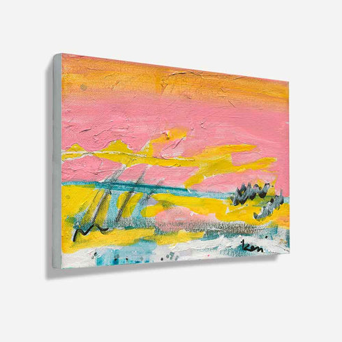 Sunset Summer art print: a horizontal landscape of a pink sky with an orange-gold band at the top, streaks of sunshine yellow, a teal horizon line, gray scribbled reeds and a white and teal foreground, printed on stretched canvas and shown at an angle