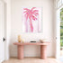Where Love Grows art print: a pink heart-patterned palm tree on a pale pink ground, in a white frame, hung above a blush-pink console table in a bright entryway