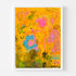 Wild Love Garden art print: a golden-orange field layered with a blue flower with a pink center, a pink blossom, olive-green patches and loose black handwritten marks, in a white frame