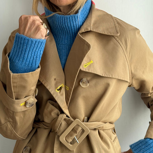 The belted, double-breasted beige trench coat is made from 100% cotton with “Sunny side up” artwork - Cute women's trench coats by Kerri Rosenthal