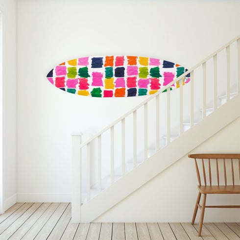 The Color My Universe Surfboard blends fine art with surf culture, adding vibrant personality to any room it’s placed in.