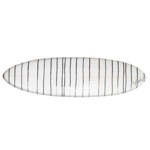 A black and white striped surfboard with a pointed tip, designed for wall display or surfing.