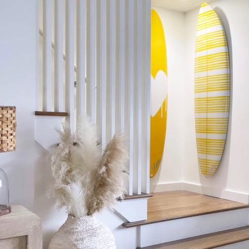 Handmade decorative surfboard with yellow and white stripes by Kerri Rosenthal