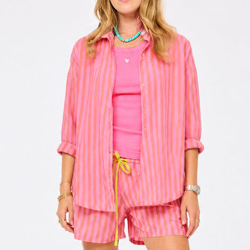 Women's pink and orange striped oversized button-down shirt and shorts co-ord set, styled with a hot pink tank top. Shop Kerri Rosenthal tank tops