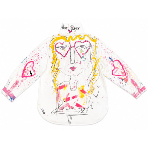 White button-down shirt hand-painted with pink heart-eyes face design, 'Heart Eyes' text on collar, heart accents on sleeves, and 'lovely' script — Kerri Rosenthal wearable art