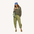 Woman wearing a blue heart-print bandana around head and army green v-neck sweater and matching pants.