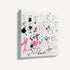 Side angle view of unframed abstract heart canvas art, showing gallery-wrap texture with black outlined hearts and pink splatter details