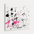 Close angled view of "I Am Love" heart painting showing textured brushwork, black outlined hearts, and pink splatter on white canvas
