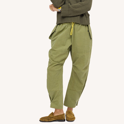 Close-up army green yellow drawstring pants with an olive top and tan suede loafers. Shop women's pants at Kerri Rosenthal