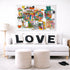 Colorful abstract art piece above a white sofa with 'LOVE' cushions in a living room setting.