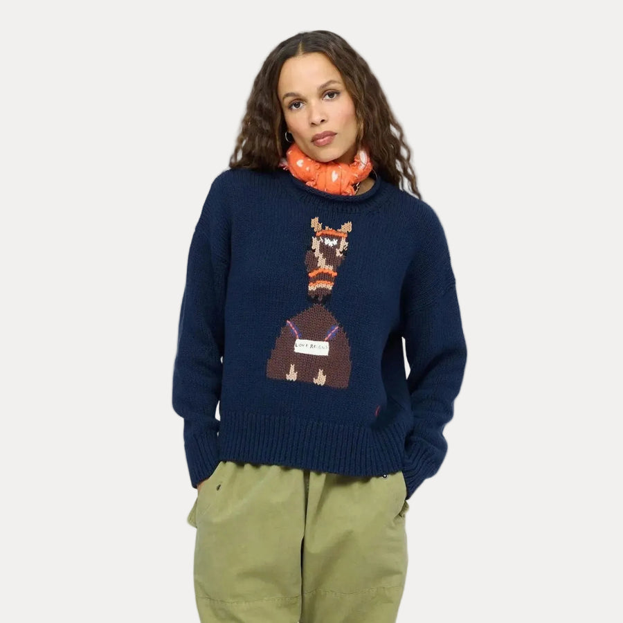 Kerri Rosenthal Roll Neck Love Reigns Sweater in indigo cotton, styled with olive pants and an orange Imperfect Heart bandana