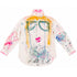 White button-down shirt hand-painted on the back with a whimsical face featuring round glasses, yellow hair, and pink lips, heart outlines on both sleeves, pink and blue paint splatters throughout, and 'Lovey' script at the hem — Kerri Rosenthal wearable art