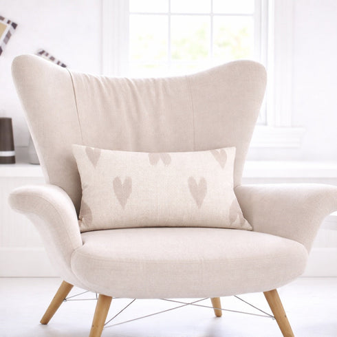 Cream colored lumbar throw pillow with heart pattern for living room chair. Cute decorative pillows by Kerri Rosenthal