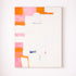 Abstract art piece with colorful geometric shapes on a white wall.