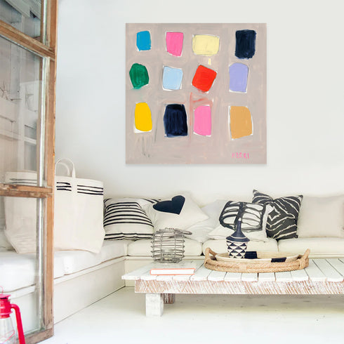 An abstract art print featuring various colored shapes on a white background, signed by the artist.