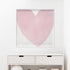 Framed pink heart artwork on a white wall above a white shelf.