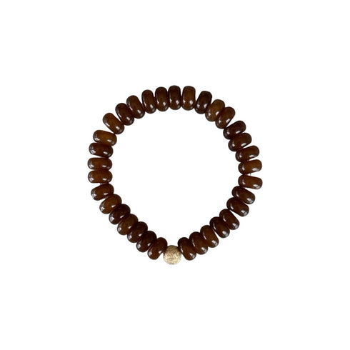 Bronze brown natural stone bead bracelet is made from smooth semi-precious stones. Smokey quartz beads with an 18K gold bead is handmade in Switzerland.