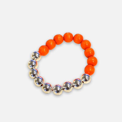 Beaded bracelet with orange and silver beads on a white background