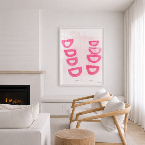 Modern living room with a fireplace, white sofa, wooden armchair, and pink abstract art on the wall.