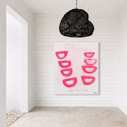 Modern interior with a black woven pendant light and abstract pink artwork on a white wall. Original painting by Kerri Rosenthal.