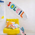 Soleil multicolor abstract letter design pillow. Crafted from the finest Belgian linen and cotton blend - Shop cute decorative throw pillows and surfboards by Kerri Rosenthal