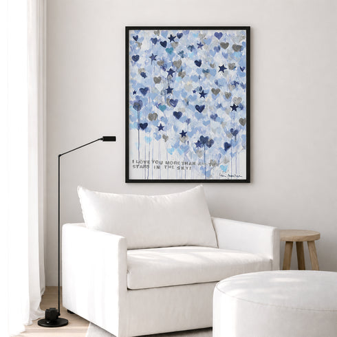 Kerri Rosenthal Starry Starry Love Vertical Art Print in black frame styled above white armchair — living room wall art inspiration.
