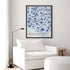 Kerri Rosenthal Starry Starry Love Vertical Art Print in black frame styled above white armchair — living room wall art inspiration.