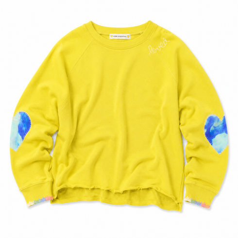 Front view of flat lay of a chartreuse sweatshirt with paint splat heart elbow patchwork and paint cuff trim.