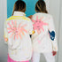 Two models wearing matching hand-painted white jackets with pink sun-face designs and 'Sunny' script lettering. Handpainted by Kerri Rosenthal