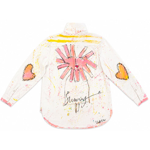 White button-down shirt hand-painted on the back with a pink sun-heart flower design, orange heart patches on both sleeves, yellow striping along the yoke, pink and yellow paint splatters throughout, and 'Sunny' script at the hem — Kerri Rosenthal wearable art