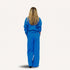 Back view of woman wearing a blue crewneck sweatshirt with and matching sweatpants with a tiny embroidered heart on back.