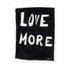 A playful way to share the positive love message "Love More" A black and white plexi frameless original word wall art painted by Kerri Rosenthal