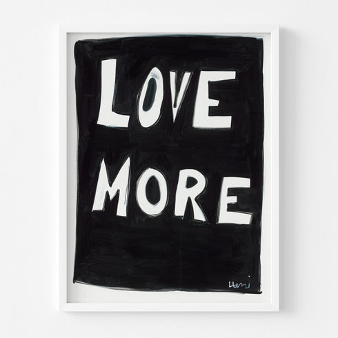 A playful way to share the positive love message "Love More" A black and white framed original word wall art painted by Kerri Rosenthal