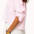 Side view of a pink striped shirt with stitched pink contrast heart elbow patched