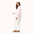 Side view of a pink striped shirt with 'LOVE' lettering and heart elbow patches and cream pants by Kerri Rosenthal