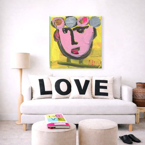 Tiki Miniki multicolor abstract wall art print with Love square throw pillows on couch for the living room by Kerri Rosenthal