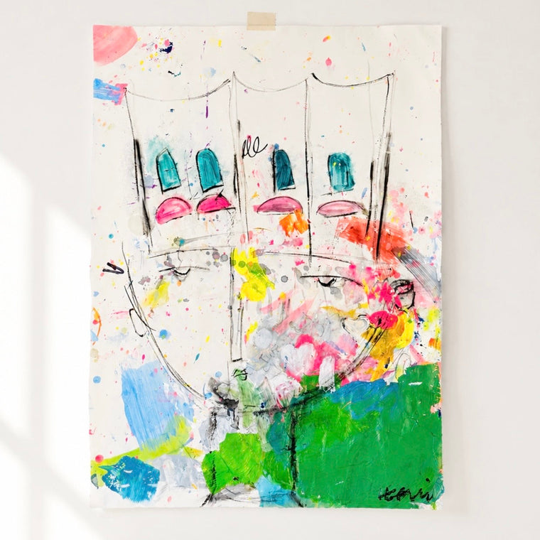 A colorful abstract canvas painting featuring stylized faces and paint splatters, displayed on a white wall in a bright room with white floorboards.