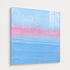 Alternate angled perspective of pastel seascape painting, highlighting dimensional canvas edge with blue sky and pink horizon in plexi frame