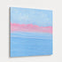 Close angled view of abstract seascape painting showing textured brushwork, soft blue waves, and pink horizon line detail