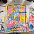 Colorful abstract drawing on paper with art supplies around