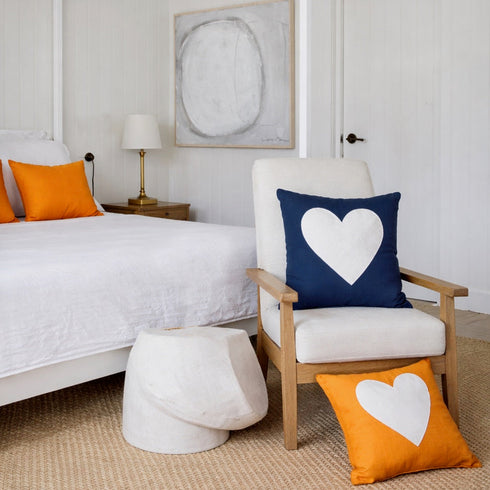 Reverse White Heart Throw Pillow with bright orange and naby backgrounds in square by Kerri Rosenthal. Cute colorful throw pillows for bedroom.