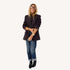 Woman wearing a coal oversized blazer with cuffed jeans, black ankle boots, and mirrored sunglasses.