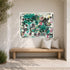Aluminum abstract canvas painting by Kerri with teal, black and pink heart motifs above wooden bench in outdoor patio entryway