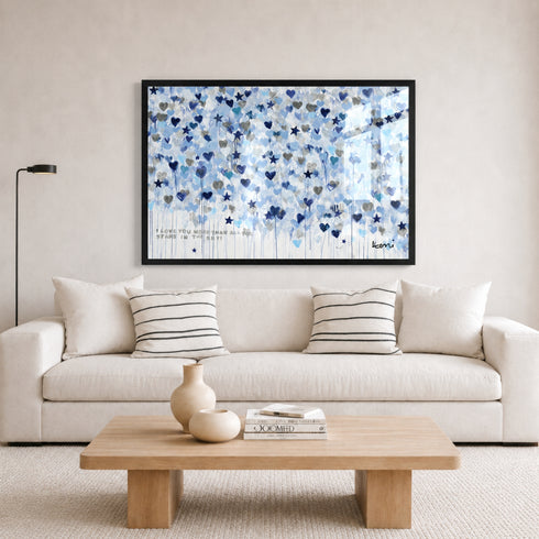 Starry Starry Love by Kerri Rosenthal — hand-painted hearts and stars in blue, navy, and grey in black frame in white living room and black and white stripe pillows.