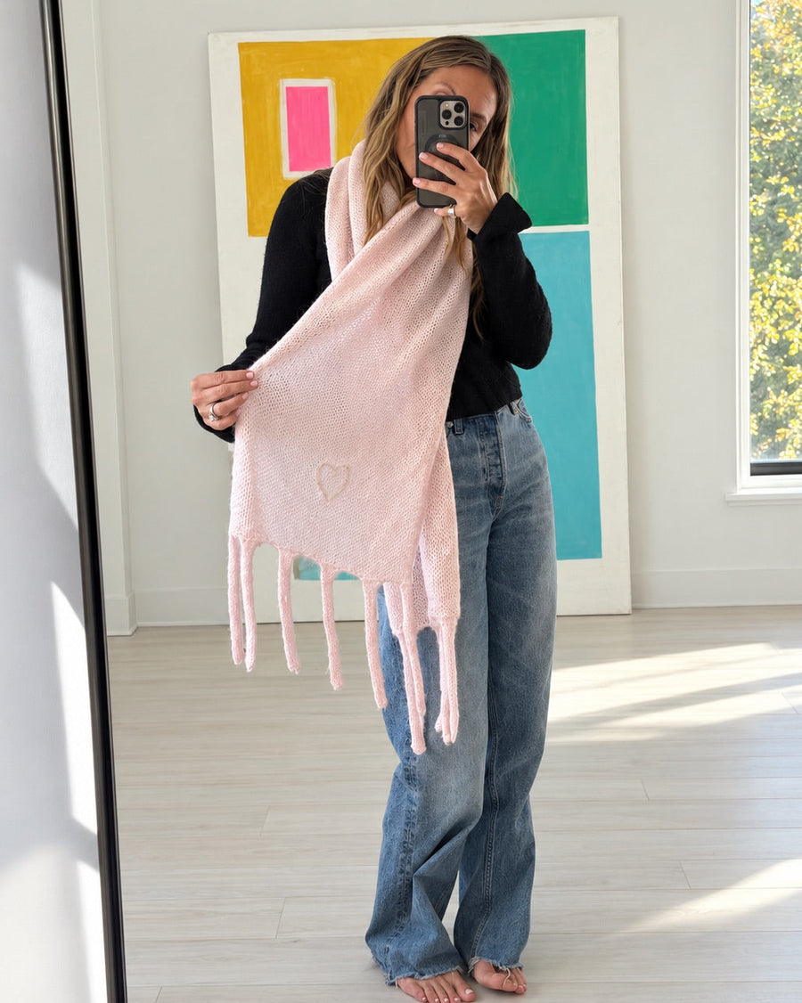 Kerri wearing the Cloud Hopping Scarf in hardly pink draped around her neck with a black top and jeans