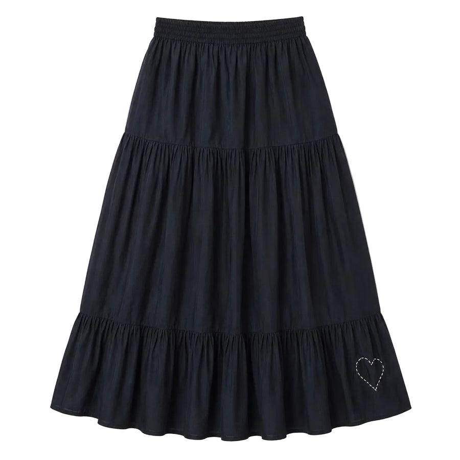 Black tiered maxi skirt with a smocked elastic waistband and a small heart embroidered near the hem. Womens clothing from Kerri Rosenthal
