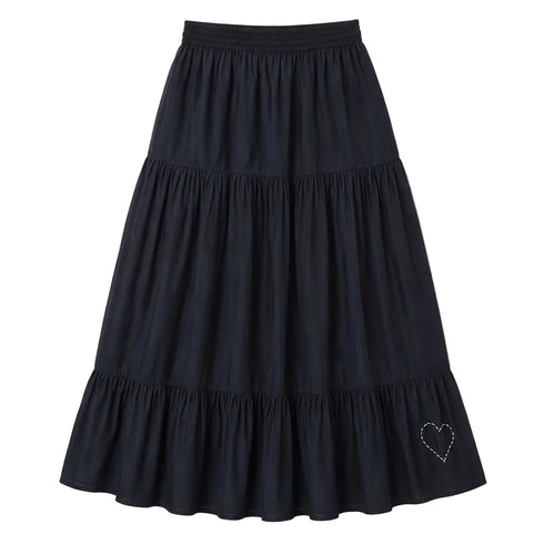 Black tiered maxi skirt with a smocked elastic waistband and a small heart embroidered near the hem. Womens clothing from Kerri Rosenthal