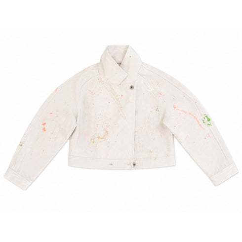 White denim cropped moto jacket with asymmetric zip front, shawl collar, and light coral and green paint splatter accents — Kerri Rosenthal wearable art"